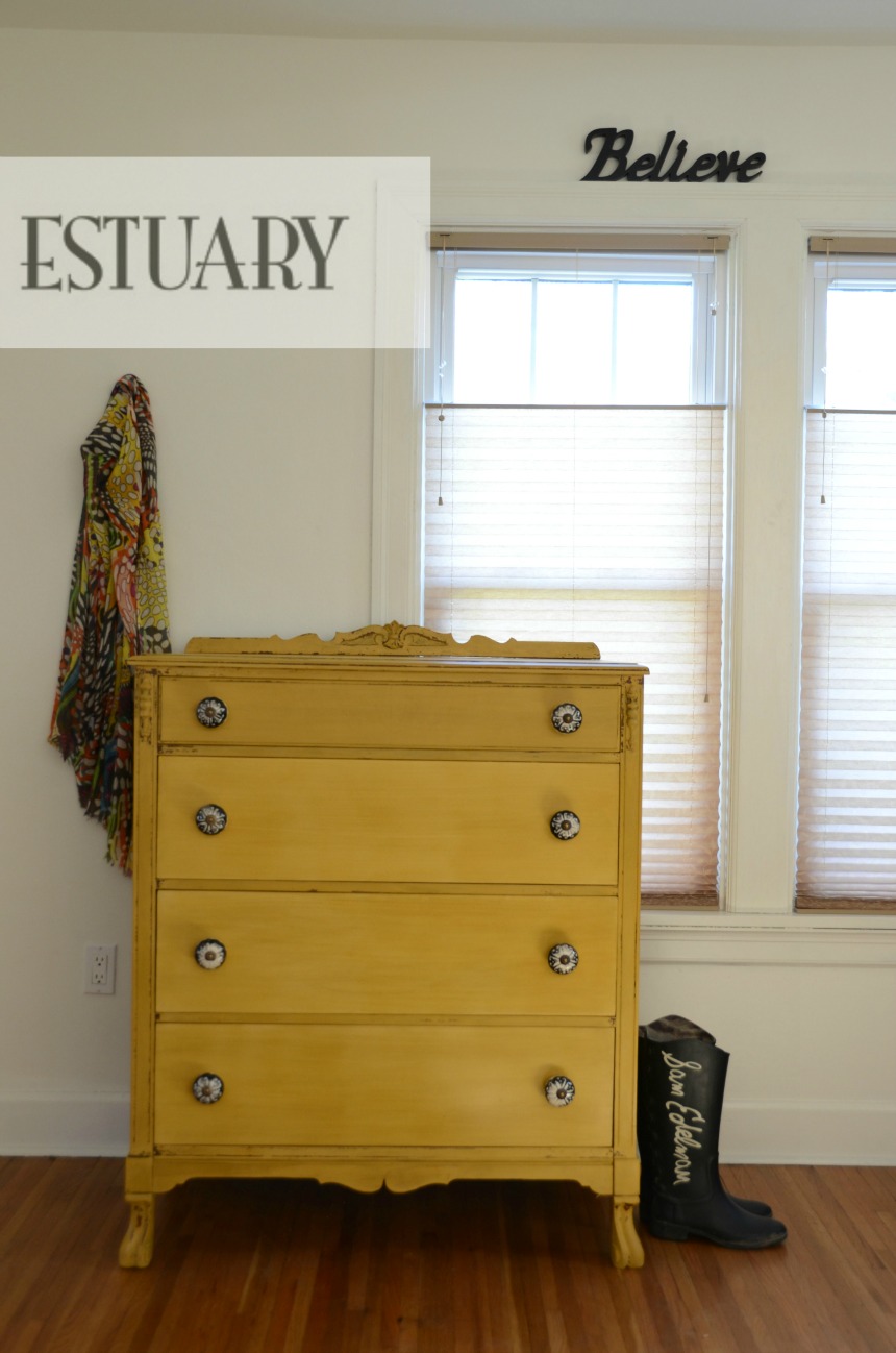 Mustard dresser with black and white knobs