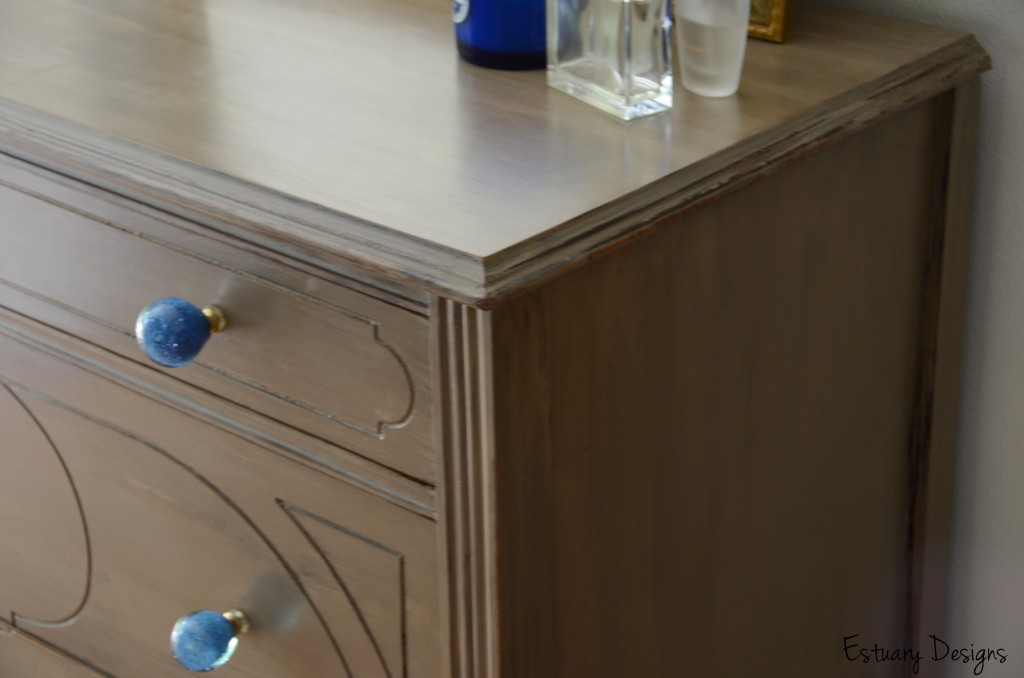 Nerissa a driftwood-esque painted dresser with blue glass knobs